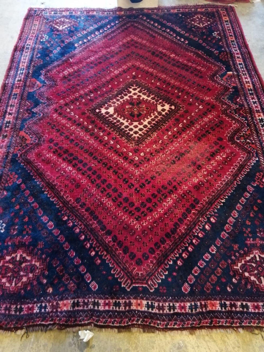 A North West Persian red ground rug, 250 x 180cm